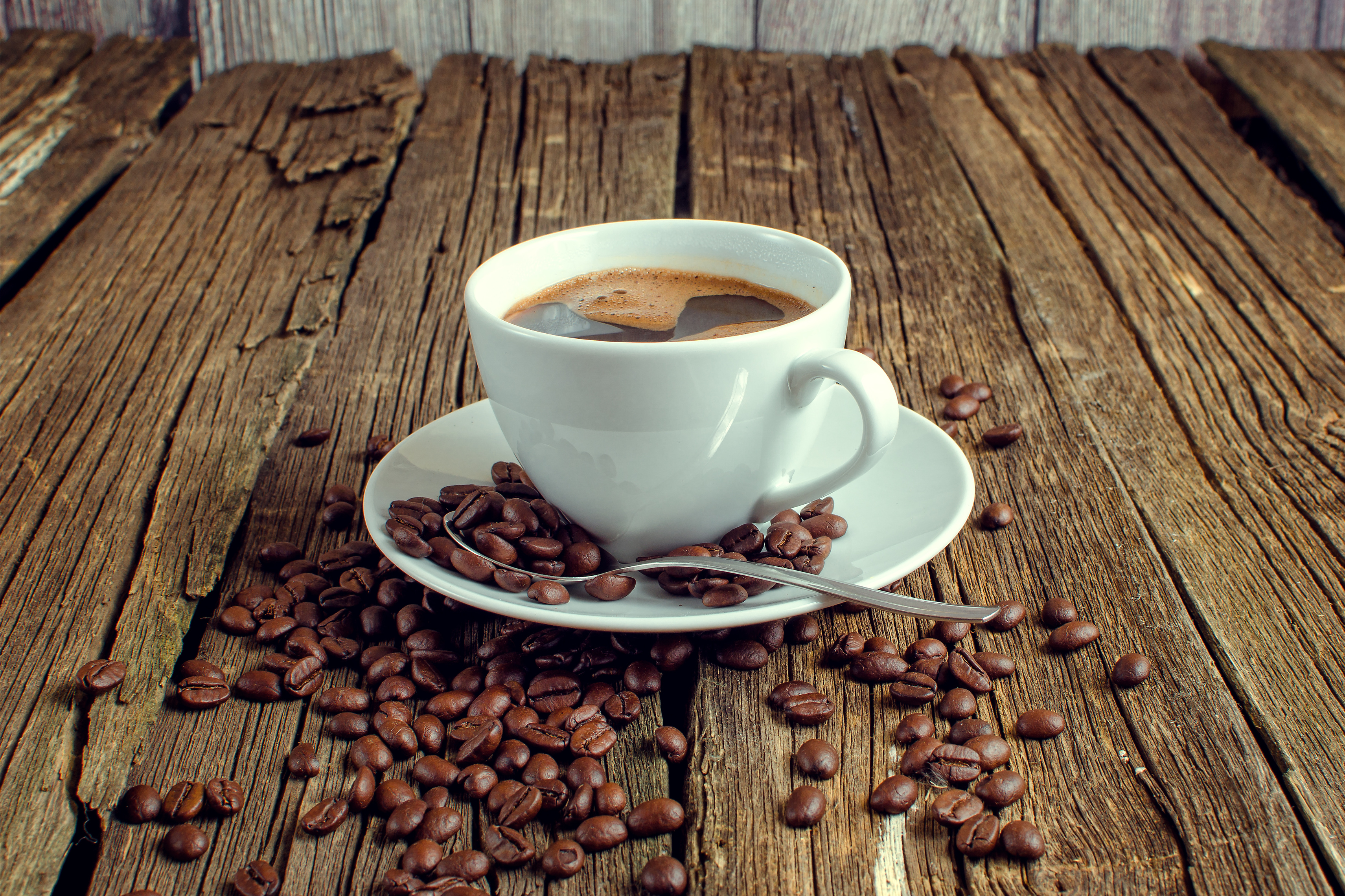 coffee Cup and coffee beans on wooden table